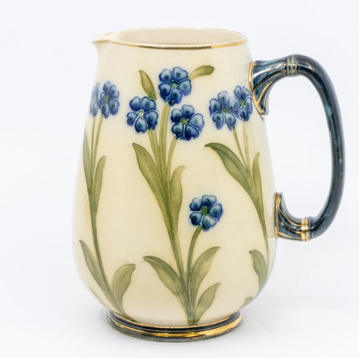 An early Macintyre Burslem England small flower-patterned jug. Approximately  15cm high. Slight wear