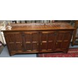 : Wilf Hutchinson. English oak panelled sideboard with four doors, cast metal hinges. Length