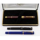 Two Parker Duofold fountain pens, with 18k gold nibs, one black one blue; together with a Plume