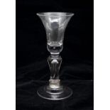 A rare Georgian baluster wine glass, circa 1725, bell bowl with air tear in the thickened base,