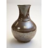 An 18th Century salt glazed stone ware jug, the rim incised "John & Elizabeth Bancroft of Barrow