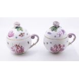 A pair of late 19th/early 20th Century Meissen chocolate cups and covers, the bodies transfer