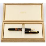 A Pilot black lacquered fountain pen, with red blossom design, 14ct gold nib, boxed