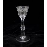 A Georgian engraved facet cut stem wine glass, circa 1770, round funnel bowl engraved with a
