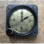 An American WWII aircraft clock, possibly from a bomber, serial number 7038, inscribed on a gold