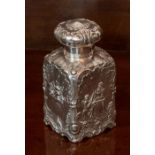 A Continental silver Tea Caddy, of square section, embossed leaves and  scrolls and embossed to
