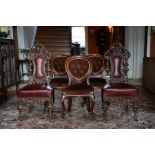 A pair of Victorian carved oak side chairs in elaborate “Jacobethan” style, the scroll pierced tops