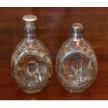 A pair of silver inlaid glass bottles, with thistle design (one lacking stopper)