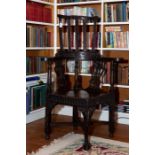 A Victorian stained oak high back corner armchair in 18th century style, with pierced splats and