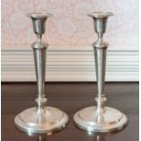 A Pair of Elizabeth II silver Candlesticks with reeded borders, plain tapered column and circular