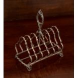 A Victorian silver seven-bar Toastrack, with pierced loop handle, raised on four pierced scroll