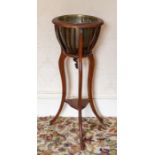 An oak and brass bound conical stick stand. An Edwardian mahogany jardiniere stand with brass liner