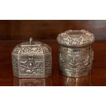 An Indian white metal cylindrical Box and Cover embossed with frieze of Indian deities, stamped ‘T.