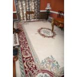 A large wool Savonnerie carpet, 20th century, with central oval floral medallion on a white ground