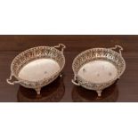 A Pair of George V silver pierced oval Baskets, each with pair of shaped handles, gadroon borders