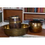 A coopered wood and brass bound ovoid bucket, of barrell shape with swing handle, 45cm high. A