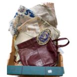 A large vintage shoulder bag, probably 1970s in maroon leather plus embroidered table linens and a