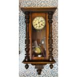 Vienna wall clock with 2 train spring driven movement chiming on a gong, contained in a stained wood