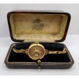 An 18 ct gold 1920s Bird in Ring ladies wristwatch. Gilded dial with Arabic numerals.  Untested