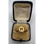 An 18 carat yellow gold signet ring with the initial "M" picked out in diamond chips. Gross weight