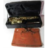 A Slade saxophone with case and a leather bag