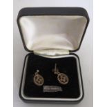 A pair of 9ct gold shaped oval earrings, the centres with cluster of small rubies (boxed)