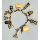 A 9ct gold charm bracelet featuring a padlock clasp, safety chain and 11 charms, to include a bell