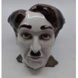 A large 20thC ceramic hand painted life like bust of Charlie Chaplin, Full size Head. stands 28cm