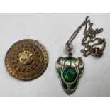 An Arts and Crafts/ Art Nouveau style green enamel foliate pendant, marked "Silver" and the
