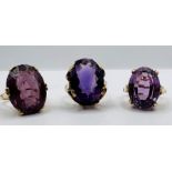 A trio of Amethyst cocktail rings, each set in 9ct gold. The first features a 16mm x 10mm amethyst