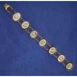 A vintage micro mosaic panel bracelet in yellow metal, assessed as base metal, with each panel