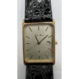 A 9ct gold Pierre Renoir watch with leather strap. Silvered dial with baton numerals. The reverse