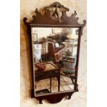 A George III “Design” mahogany and gilt mirror, pierce scrolling shaped crest rail with a carved