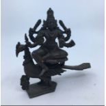 A 20th century Indian bronze figure of a deity, possibly Kartikeya, riding upon peacock, cast in two