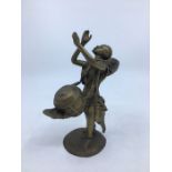A 20th century Far Eastern brass figure of a man with a drum, height 16.5cm.