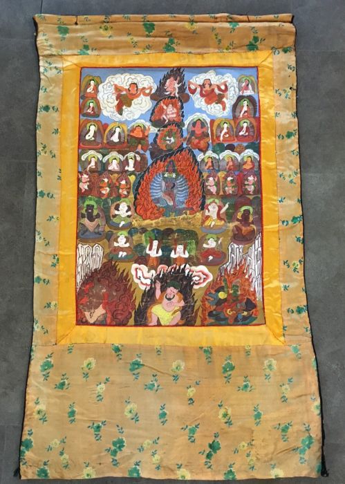 A late 20th century Sino-Tibetan Thangka, gouache on cotton within silk border, 62cm x 105cm. - Image 2 of 5