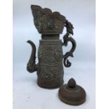 A 20th century Sino-Tibetan copper teapot, the pierced rim with opposing turqoiuse set tear drop,