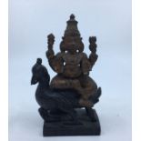 A 20th century Indian carved wooden deity, probably Vishnu, riding upon peacock, height 14.5cm.