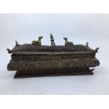 An early 20th centruy Sino-Tibetan rectangular copper incense box and cover, embossed to sides,