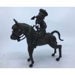 A mid 20th century African copper alloy figure of a warrior on a horseback, height 24cm..