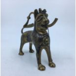 A 20th centruy Indian brass and white metal figural vessel in the form of a lion, with spout to