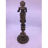 A 19th century Indian brass figural lamp, fashioned in two parts, the top with figure (lacking