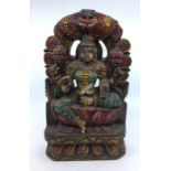 A modern Indian carved and polychrome painted wooden figure of a four armed deity, height 30.5cm.