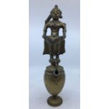 A 19th century Indian brass figural oil lamp, fashioned in two parts, with figural lamp to top (