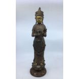 A large late 19th/early 20th century Chinese cast iron figure of Guanyin, retaining traces of gilt