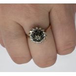 A sapphire and diamond cluster ring in yellow metal stamped "RDP" and "CT 18". Gross weight