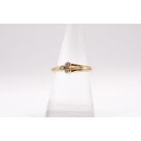 A 9ct gold diamond ring featuring thre small diamonds in bezel settings. Size N. Approximate