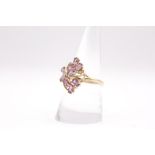 A 9ct gold foliate designn Amethyst and Diamond dress ring. Approximate weight 3.2 grams. Size Q.