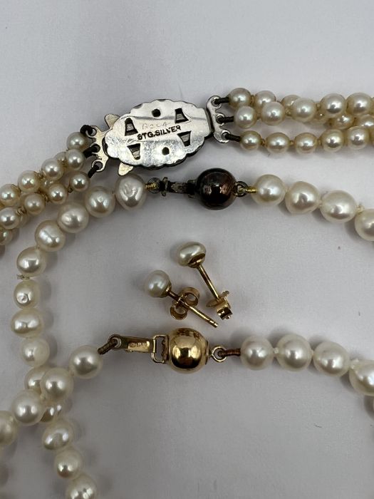 A selection of cultured pearl jewellery comprising a 3 strand necklace with a marcasite and silver