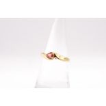 An 18ct yellow gold dress ring set with a pear shaped orangey-red sapphire. Size N. Gross weight